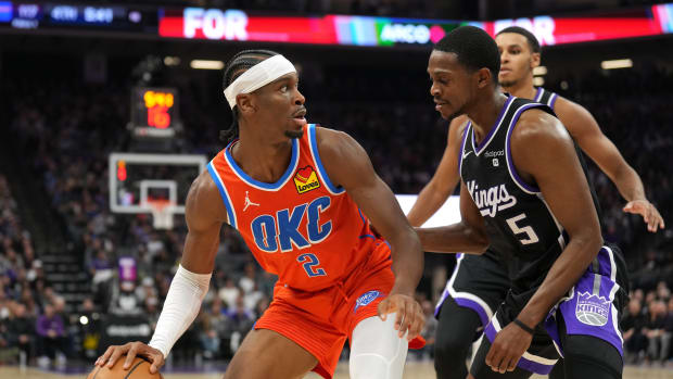 Dec 14, 2023; Sacramento, California, USA; Oklahoma City Thunder guard Shai Gilgeous-Alexander (2) dribbles against Sacramento Kings guard De'Aaron Fox (5) during the fourth quarter at Golden 1 Center. Mandatory Credit: Darren Yamashita-USA TODAY Sports  